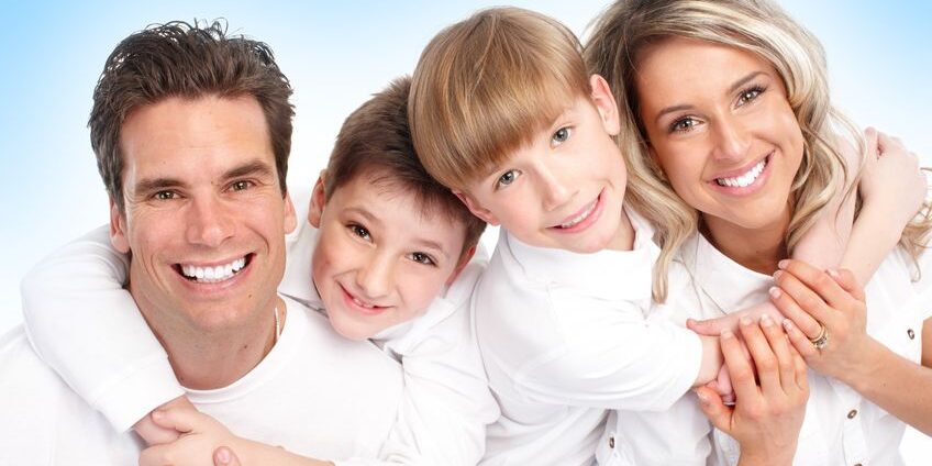 family smiling in white